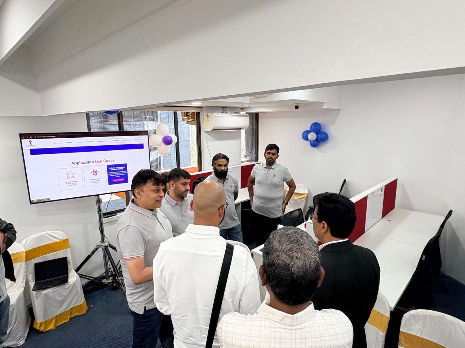 Team members walking guests through the tiramai platform on a screen at the new office