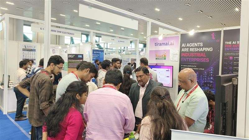 A tiramai co-founder in conversation with visitors at the stall