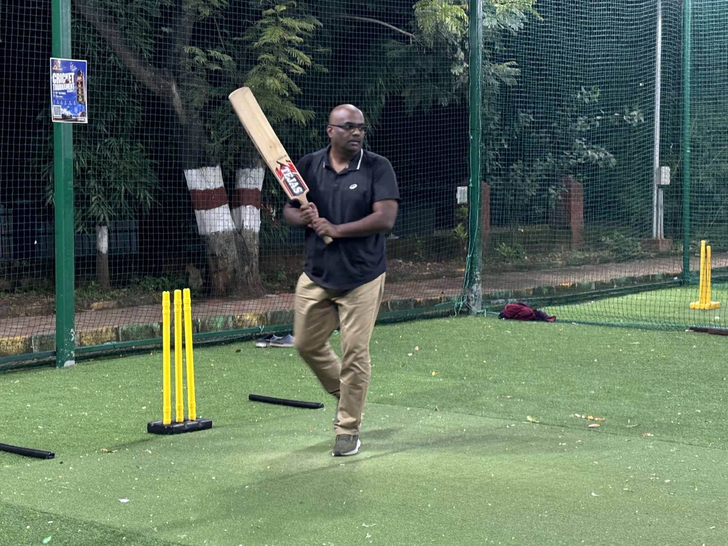 A tiramai team member at the crease with the bat raised, ready for the next ball
